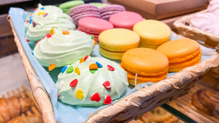 Marshmallows and macaroons of different colors lie on the counter of the pastry shop