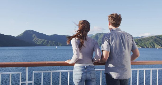 New Zealand travel people enjoying nature view of ferry boat cruise in Marlborough Sounds trip from Picton to Wellington, Cook strait crossing. Couple tourists watching sunset vacation.