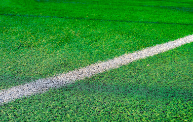 White stripe on green grass, on the football field. Football field with markings.