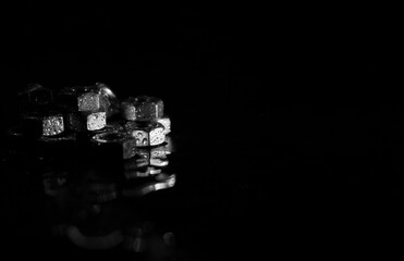 screw-nuts with water drops on a dark surface