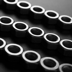 screw-nuts on a dark surface