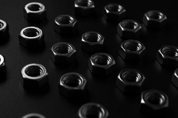 screw-nuts on a dark surface