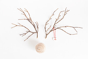 Christmas reindeer concept made of branches and xmas bauble on white background