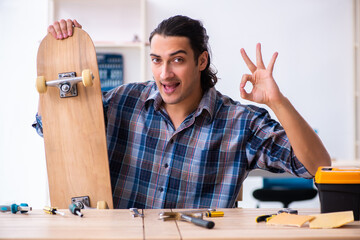 Young man repairing skateboard at workshop