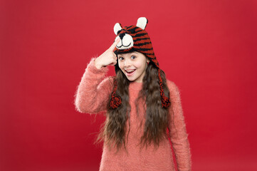 smiling teen girl in cozy warm wear demonstrate winter hat, knitting