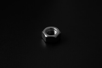 screw-nut on a dark surface