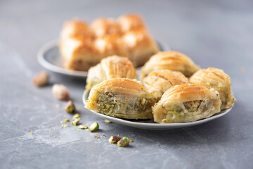 Middle eastern dessert baklava with pistachios on grey background. Copy space. Banner. Turkish delight baklava, traditional eastern arabian sweets