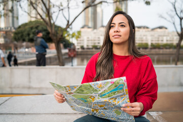 Young traveler woman with a map.