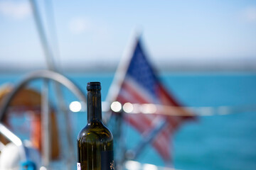 a bottle of wine on the background of the American flag