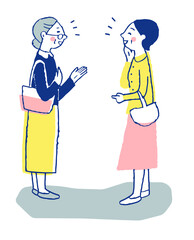 笑顔で立ち話をする女性2人