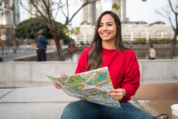 Young latin woman with a map.