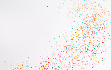 Lots of bright Christmas confetti on a white isolated background top view
