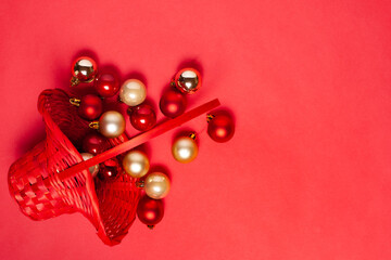 mock up of a red wicker basket on the side with scattered red and silver Christmas tree balls on a saturized background.