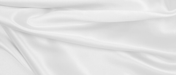 Smooth elegant white silk or satin luxury cloth texture as wedding background. Luxurious background design