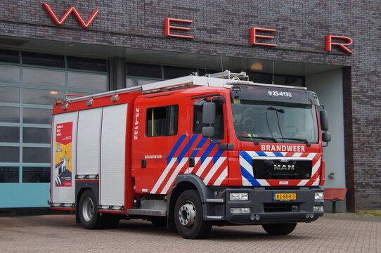 Almere, The Netherlands - May 19, 2016: Dutch fire engine standing in font of a fire station. Nobody in de vehicle.