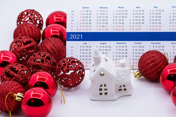 calendar 2021 and Christmas balls, toy house and calendar 2021, red Christmas balls and house