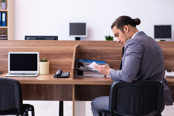 Young male employee working in the office