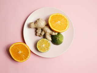 healthy citrus and ginger on pink bakcground