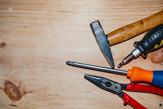 Kit of working tools on wooden background