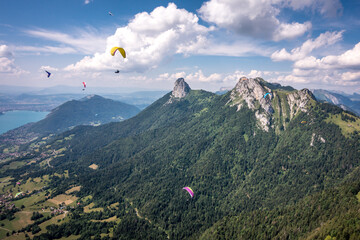 Paragliders & Hang Gliders Fly Over Granite Alps, Lake Annecy, France