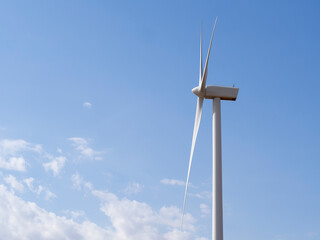 Wind turbine generator view with blades spinning around