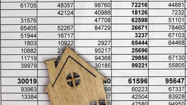 financial report with number tables with model of  wooden house, business concept for finance