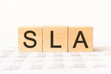 Word sla. Wooden small cubes with letters isolated on white background with copy space available.Business Concept image.