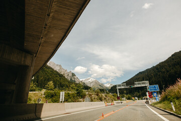 Alpine road landscape forest, mountains and blue sky on background at bright sunny day. Holiday summer vacation. scenic austrian landscape Alpine road, motorways