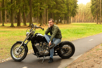 Obraz na płótnie Canvas Beautiful young man, road, motorcycle