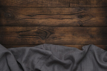 Gray linen cloth on wooden background. Copy space for text.