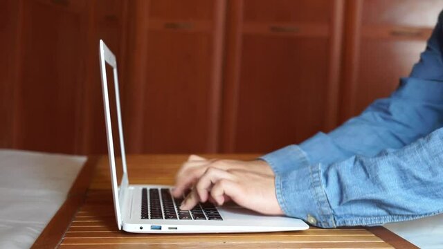 Office worker working and typing on his computer.
