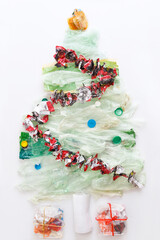 Christmas tree, gifts from plastic waste, white background,  flat lay
