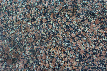 Red gray polished granite close-up texture background