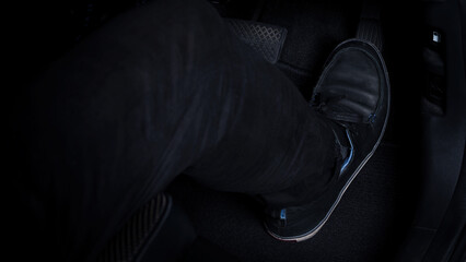 Close up images of man driving car by pushing accelerator and brake pedal with right foot black...