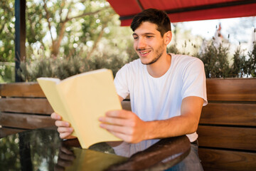Fototapeta premium Man enjoying free time and reading a book.