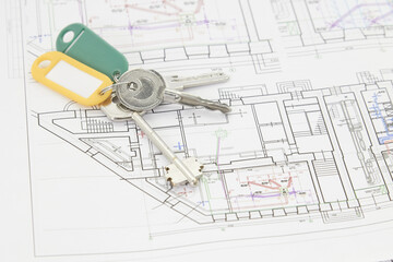 architectural drawings on a white sheet with keys to the house, the concept of construction and design of real estate