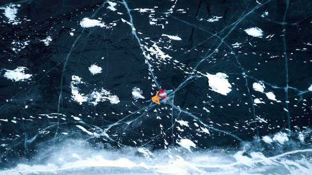 aerial view of a lovely couple in the middle of a frozen river