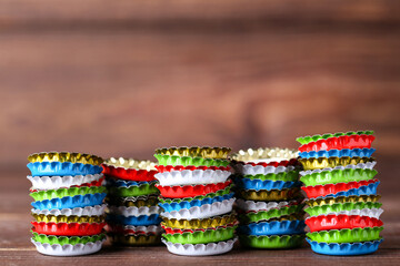 Colorful bottle caps on brown wooden table