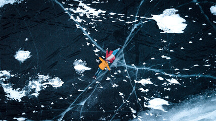 aerial view of a lovely couple in the middle of a frozen river
