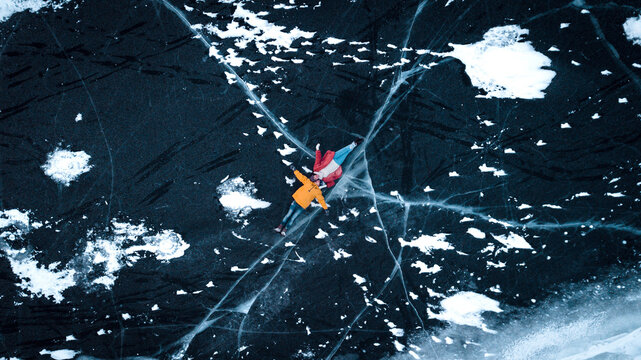aerial view of a lovely couple in the middle of a frozen river