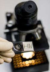close-up front view of an AIDS sample, placed on a slide for the laboratory microscope.