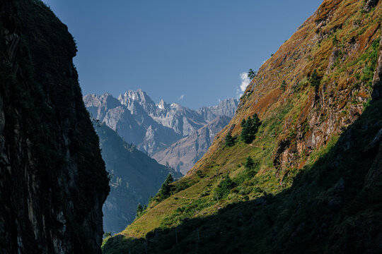 Nepalese landscape - mountain slopes and snowy peaks on the background