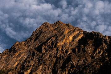 Landscape of a rocky mountain range golden toned with a sunset light