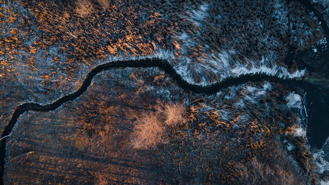 Skyshot of a frozen river on the sunset