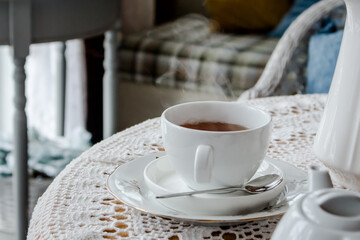 a Cup of steamed tea in a cozy room
