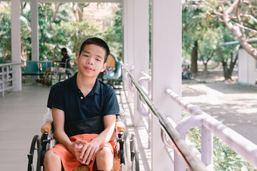 Disabled child on wheelchair is smiling,playing,learning in the outdoor park activity like other people,Lifestyle of special kid, Life in the education age of children, Happy disability kids concept.