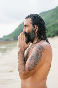 Hermit praying on desolate beach