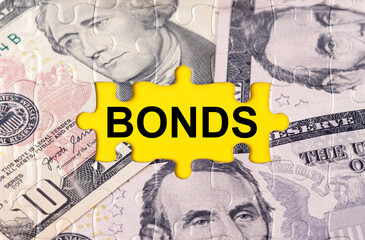 Puzzle with the image of dollars in the center of the inscription -BONDS