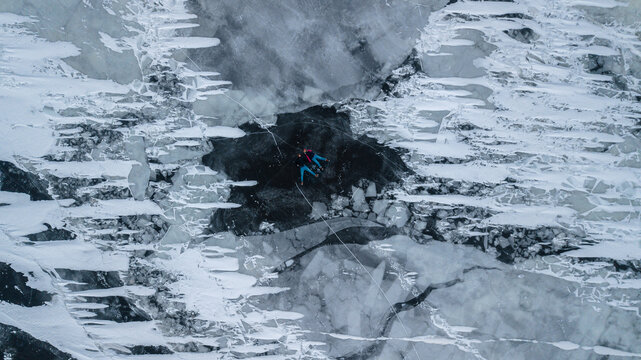 aerial view of a lovely couple in the middle of a frozen river