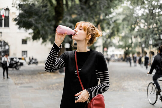 Young Girl Drinking From Steel Water Bottle
